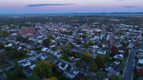 Wide-aerial-shot-of-American-town-during-autumn-sunrise-at-dawn