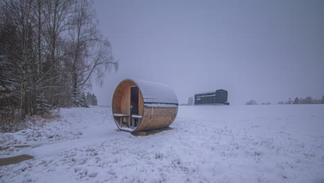 Timelapse-of-a-sauna-and-a-cabin,-weather-and-seasons-changing-on-the-countryside