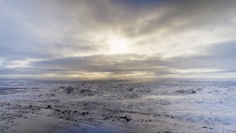 Sunlight-poking-trhough-clouds-above-arctic-tundra