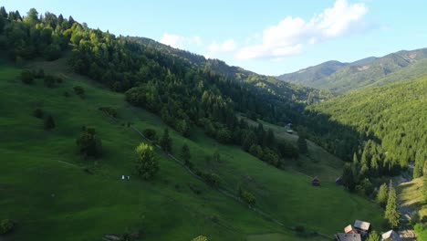 Aerial-View-Of-Green-Mountain-With-Trees,-Forest-And-Houses