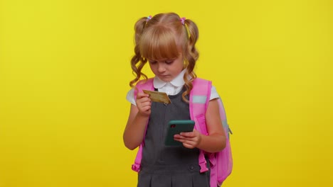 Teenage-girl-kid-in-school-uniform-using-credit-bank-card-and-smartphone,-purchases-online-shopping