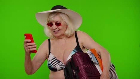 Senior-pensioner-woman-tourist-taking-selfie-portrait-photo,-making-video-call-on-mobile-phone