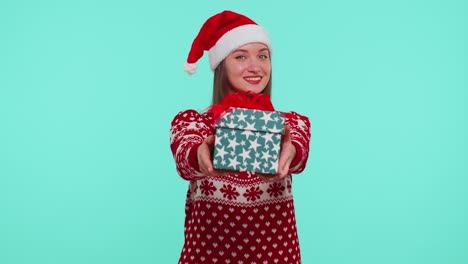 Joyful-girl-in-red-Christmas-sweater-with-deers-presenting-Christmas-gift-box,-shopping-holiday-sale