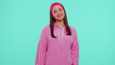 Cheerful-lovely-teenager-student-girl-fashion-model-in-pink-hoodie-smiling-and-looking-at-camera