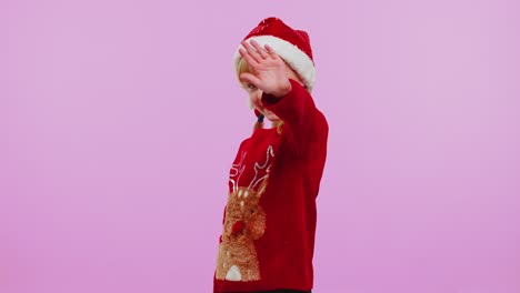Girl-in-Christmas-sweater-waves-hand-palm-in-hello-gesture-welcomes-someone-to-celebrate-New-Year