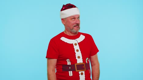 Crazy-man-in-Santa-Christmas-t-shirt-hat-demonstrating-tongue-out,-fooling-around-making-silly-faces