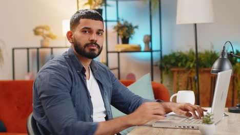 Confused-Indian-man-working-on-laptop-having-doubts-no-answer-idea-being-clueless-at-home-office