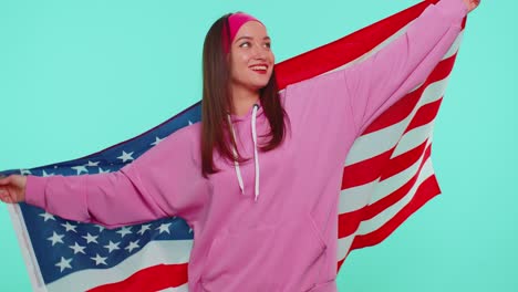 Cheerful-teen-girl-waving-and-wrapping-in-American-USA-flag,-celebrating,-human-rights-and-freedoms