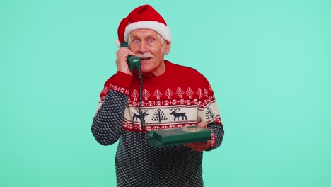 Senior-Christmas-grandfather-man-talking-on-wired-vintage-telephone-of-80s,-say-hey-you-call-me-back