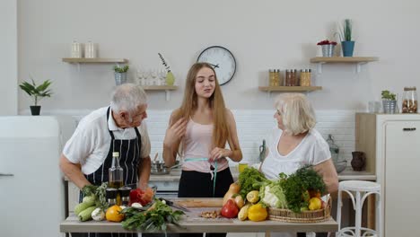 Girl-measuring-with-tape-measure-her-slim-waist-and-braging-in-front-of-grandparents.-Raw-food-diet