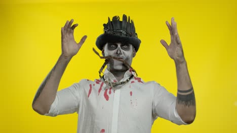 Crazy-man-with-horrible-Halloween-skeleton-makeup-appears-from-bottom-side,-trying-to-scare