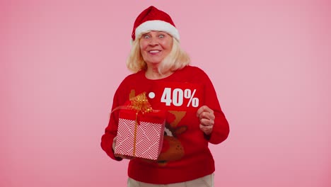 Grandmother-in-Christmas-sweater-showing-gift-box-and-40-Percent-discount-inscriptions-banner-text