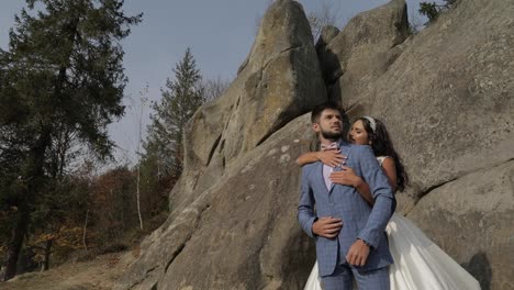 Groom-with-bride-near-mountain-hills.-Wedding-couple.-Happy-family-in-love