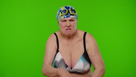 Mature-woman-swimmer-in-swimsuit-showing-negative-emotions,-hate,-rage,-upset,-stress-on-chroma-key