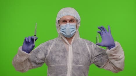 Doctor-in-PPE-suit-with-vaccine-ampoule,-syringe-in-hands-offering-vaccination-against-coronavirus