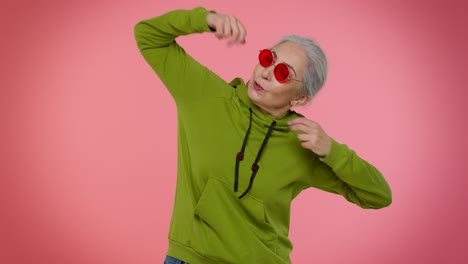 Senior-woman-listening-music-dancing-disco-fooling-around-having-fun-expressive-gesticulating-hands
