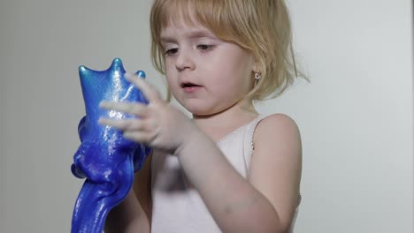 Child-having-fun-making-slime.-Kid-playing-with-hand-made-toy-slime.