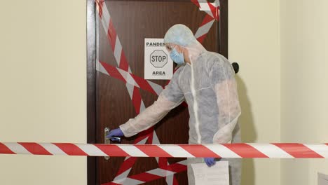 Medical-worker-opening-entrance-door,-sick-family-of-woman-with-daughter-at-home-during-coronavirus
