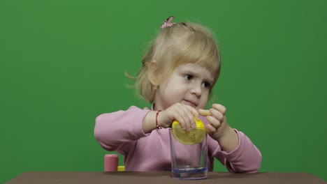 Beautiful-young-girl-squeezes-lemon-juice-with-a-grimace-on-her-face