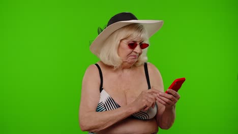 Senior-woman-tourist-browsing-on-mobile-phone-app,-looking-for-resort-hotel-on-chroma-key-background