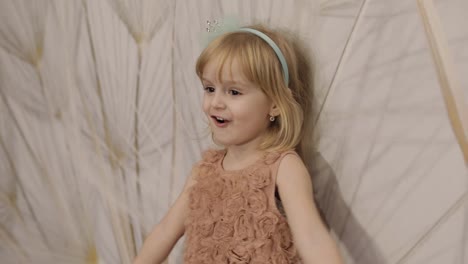 Happy-three-years-old-girl-make-faces-and-dancing.-Cute-blonde-child