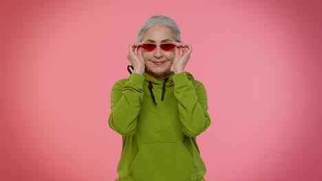 Portrait-of-seductive-senior-elderly-old-granny-gray-haired-woman-wearing-sunglasses,-charming-smile