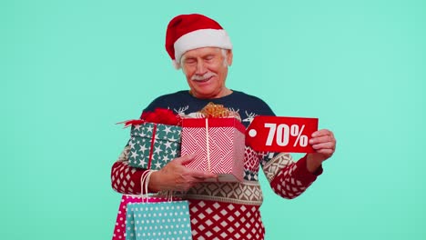 Mature-man-in-Christmas-sweater-showing-gift-box-and-70-Percent-discount-inscriptions-banner-text