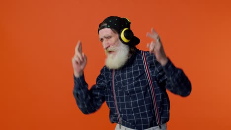 älterer-Alter-Mann,-Der-über-Kopfhörer-Musik-Hört,-Tanzt-Und-Disco-Spielt-Und-Spaß-Hat-Und-Mit-Den-Händen-Gestikuliert