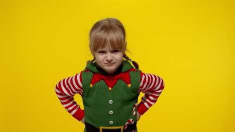 Displesed-kid-teenager-girl-in-elf-Santa-helper-costume-negative-emotions,-upset-on-Christmas-Eve