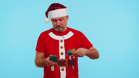 Man-in-Christmas-red-t-shirt-use-mobile-cell-phone,-plastic-credit-bank-cards,-win,-calebrate,-wow