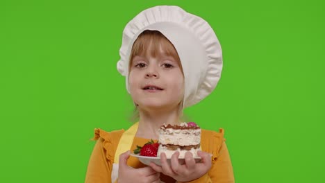 Child-girl-kid-dressed-as-professional-cook-chef-showing-eating-tasty-handmade-strawberry-cake