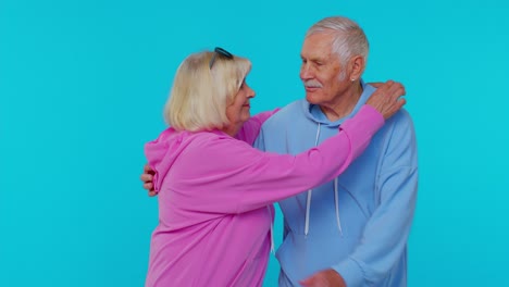 Cheerful-lovely-senior-couple-man-woman-grandparents-smiling-hugging-enjoying-lifestyle-together