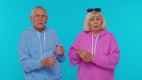 Displeased-senior-old-couple-man-woman-grandparents-gesturing-hands-with-irritation-and-displeasure