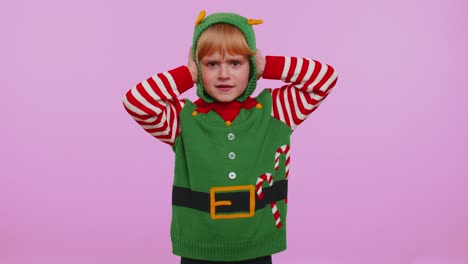 Girl-kid-Christmas-Elf-covering-ears-and-gesturing-no,-avoiding-advice-ignoring-unpleasant-noise