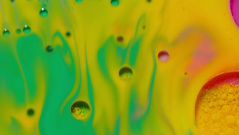 Bright-neon-colorful-bubbles-oil-and-ink,-acrylic-paint-moving-close-up,-wallpaper-background