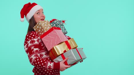 Girl-in-Christmas-red-sweater,-Santa-hat-smiling,-holding-many-gift-boxes-New-Year-presents-shopping