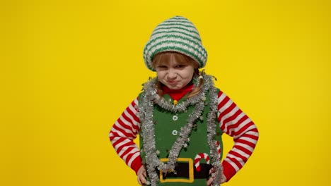 Displeased-girl-in-Christmas-elf-Santa-helper-costume-looking-unhappily-angry,-sad.-Negative-emotion
