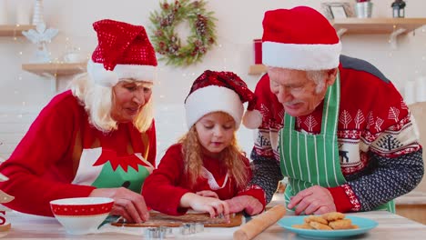 Senior-family-grandmother,-grandfather,-granddaughter-preparing,-cooking-homemade-Christmas-cookie