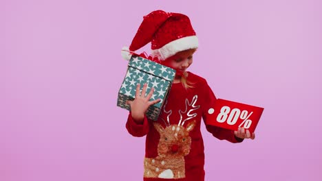 Toddler-girl-in-Christmas-hat-showing-gift-box-and-80-Percent-discount-inscriptions-banner-text-note