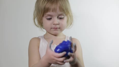 Child-having-fun-making-slime.-Kid-playing-with-hand-made-toy-slime.