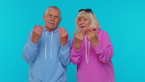 Senior-grandparents-pensioners-showing-inviting-gesture-with-hands,-ask-to-join,-beckoning-to-coming