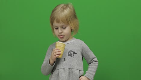 Kid-girl-eat-ice-cream-on-a-Green-Screen,-Chroma-Key