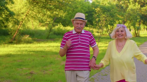 Happy-senior-stylish-couple-family-grandmother-grandfather-enjoying-date,-dancing-in-summer-park