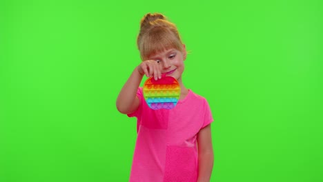 Child-girl-kid-playing-squeezing-anti-stress-pop-it-touch-screen-toys-simple-dimple-game,-chroma-key