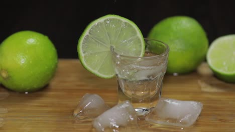 Pouring-vodka-or-tequila-into-shot-glasses-with-ice-cubes