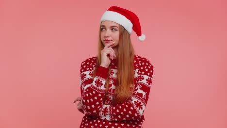 Excited-girl-in-Christmas-sweater-make-gesture-raises-finger-came-up-with-creative-plan-good-idea