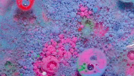 Top-view-movement-of-blue-pink-oil-ink-drops-bubbles,-multicolored-artistic-paint-surface-background