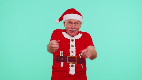 Senior-Christmas-grandfather-man-smiling-excitedly,-pointing-to-camera,-beauty-choosing-lucky-winner