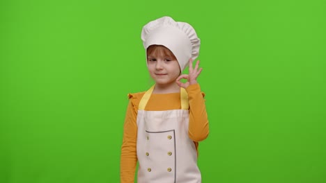 Child-girl-dressed-in-apron-like-chef-cook-showing-approval-ok-sign,-tasty-gesture,-chroma-key