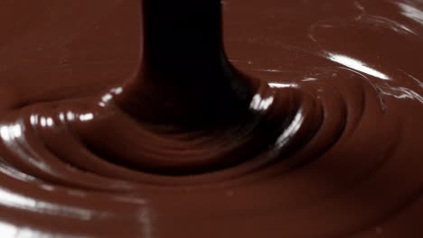 Pouring-melted-liquid-premium-dark-or-milk-chocolate-with-nuts,-preparing-confectionery-dessert